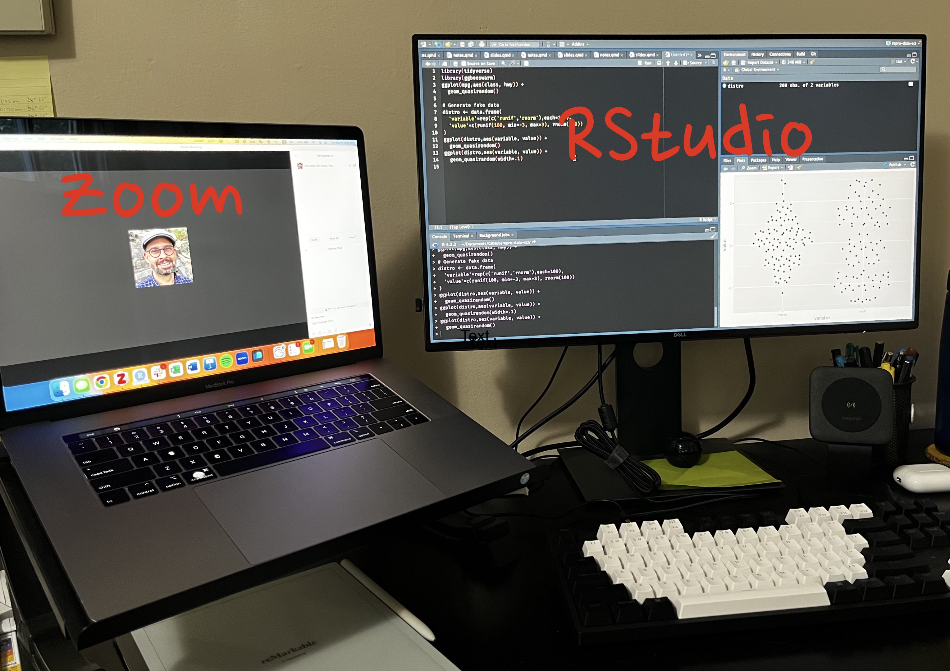 Photo of a desk with a laptop on a laptop stand to the left and a larger monitor to the right in front of an external keyboard.  Laptop monitor has Zoom open and the larger monitor has RStudio open.